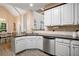Well-lit kitchen featuring stainless steel appliances, light countertops, and stylish cabinets, offering modern convenience at 492 Thorn Creek Way, Dallas, GA 30157