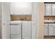 Convenient laundry closet with a modern, white washer and dryer and storage space at 492 Thorn Creek Way, Dallas, GA 30157
