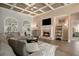 Bright living room with coffered ceiling, fireplace, large windows, and comfortable sectional sofa at 492 Thorn Creek Way, Dallas, GA 30157