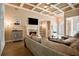 Spacious living room with fireplace, coffered ceilings, and wood floors, creating an elegant and welcoming atmosphere at 492 Thorn Creek Way, Dallas, GA 30157