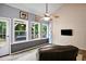 Bright sunroom featuring three windows with wooded views and a ceiling fan at 492 Thorn Creek Way, Dallas, GA 30157