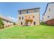 Back exterior view of the home featuring a backyard and an upper level deck at 9183 Golfview Cir, Covington, GA 30014