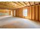 Unfinished basement space with concrete floors, exposed ceiling and natural light, ready for customization at 9183 Golfview Cir, Covington, GA 30014