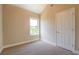 Cozy bedroom featuring carpet, a bright window, and neutral walls at 9183 Golfview Cir, Covington, GA 30014