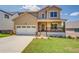 Charming two-story home with a welcoming front porch and a well-manicured lawn at 9183 Golfview Cir, Covington, GA 30014