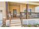 Cozy front porch with decorative columns and a beautifully crafted front door at 9183 Golfview Cir, Covington, GA 30014