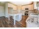 Bright kitchen featuring white cabinets, granite countertops and stainless steel appliances at 9183 Golfview Cir, Covington, GA 30014