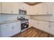 Modern kitchen with granite countertops, stainless steel appliances and white cabinets at 9183 Golfview Cir, Covington, GA 30014