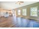 Bright open-concept living room with hardwood floors and windows overlooking the backyard at 9183 Golfview Cir, Covington, GA 30014