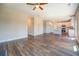 Open-concept living room with hardwood floors and view into kitchen with stainless appliances at 9183 Golfview Cir, Covington, GA 30014