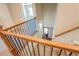 Elegant staircase with wood railings and iron balusters, leading to the front door at 9183 Golfview Cir, Covington, GA 30014