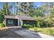 Cozy exterior view of home with black siding, green trim, and mature landscaping at 161 Aaron Ct, Riverdale, GA 30274