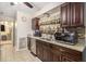 Functional kitchen featuring dark cabinets, granite countertops, and stainless steel appliances, ideal for culinary enthusiasts at 161 Aaron Ct, Riverdale, GA 30274