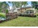 Lush backyard featuring a pool, greenery, and the home's exterior with a sunroom at 3007 Frazier Ct, Decatur, GA 30033