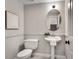 Powder room includes pedestal sink, framed mirror, modern fixtures, and neutral color palette at 3007 Frazier Ct, Decatur, GA 30033