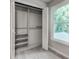 Bedroom closet with shelving, hanging rod, and window at 3007 Frazier Ct, Decatur, GA 30033