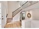 Grand foyer with hardwood floors, staircase with iron railing, and abundant natural light at 3007 Frazier Ct, Decatur, GA 30033