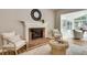 Bright and airy living room with fireplace, hardwood flooring, neutral paint, and large windows at 3007 Frazier Ct, Decatur, GA 30033