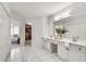 Light-filled main bathroom with double vanity and access to walk-in closet at 3007 Frazier Ct, Decatur, GA 30033