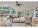 Light-filled sunroom boasting hardwood flooring, neutral paint, large windows, and backyard views at 3007 Frazier Ct, Decatur, GA 30033