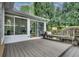 Relaxing outdoor deck area with a sunroom, bench, and scenic backyard views at 3007 Frazier Ct, Decatur, GA 30033
