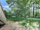 Backyard features mature trees offering ample shade and natural beauty at 3163 Old 41 Nw Hwy, Kennesaw, GA 30144