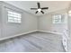 Well-lit bedroom with wood-look floors, neutral paint, two windows, and a ceiling fan at 3163 Old 41 Nw Hwy, Kennesaw, GA 30144