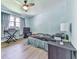 Cozy bedroom with wood-look floors, natural light from the window, and ceiling fan at 3163 Old 41 Nw Hwy, Kennesaw, GA 30144