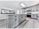 Spacious kitchen with island, gray cabinets, stainless steel appliances, and modern lighting at 3163 Old 41 Nw Hwy, Kennesaw, GA 30144