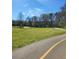 A paved pathway meanders through a large grassy field at 3163 Old 41 Nw Hwy, Kennesaw, GA 30144