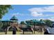 A vibrant playground featuring slides, climbing structures, and protective fencing set against a blue sky at 3163 Old 41 Nw Hwy, Kennesaw, GA 30144