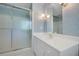 Bathroom featuring a glass shower, white cabinets, and blue wallpaper at 3999 Saint Clair Ne Ct, Brookhaven, GA 30319