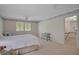 Large bedroom features neutral carpet, a window with shutters, and a doorway to another room at 3999 Saint Clair Ne Ct, Brookhaven, GA 30319