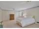 Bright bedroom with hardwood dresser, ceiling fan, and natural light from a shuttered window at 3999 Saint Clair Ne Ct, Brookhaven, GA 30319