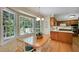 Sunny dining area with large windows, wooden table and chairs and kitchen view at 3999 Saint Clair Ne Ct, Brookhaven, GA 30319
