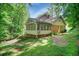 Exterior view of the back of the house with a screened-in porch at 3999 Saint Clair Ne Ct, Brookhaven, GA 30319