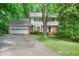 Charming two-story home with a brick and light yellow facade, attached garage, and a well-maintained lawn at 3999 Saint Clair Ne Ct, Brookhaven, GA 30319