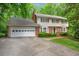 Charming two-story home with a brick and light yellow facade, attached garage, and a well-maintained lawn at 3999 Saint Clair Ne Ct, Brookhaven, GA 30319