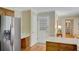 A view of the eat-in kitchen area, including a stainless steel refrigerator and an exterior door at 3999 Saint Clair Ne Ct, Brookhaven, GA 30319