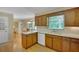 Well-lit kitchen with classic wood cabinetry, bright countertops, and views into the dining area for easy access at 3999 Saint Clair Ne Ct, Brookhaven, GA 30319