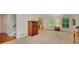 Spacious living room with large windows, neutral carpet, and open access to dining area, ideal for entertaining at 3999 Saint Clair Ne Ct, Brookhaven, GA 30319