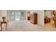 Bright living room with large windows, neutral carpet, and open access to dining area, creating an inviting atmosphere at 3999 Saint Clair Ne Ct, Brookhaven, GA 30319