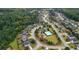 Aerial view of a community with lush greenery and well-maintained homes, featuring a pool at 6140 Stillwood Ln, Cumming, GA 30041