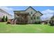 Spacious backyard with lush green grass and a covered deck, perfect for outdoor activities at 6140 Stillwood Ln, Cumming, GA 30041