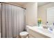 Well-lit bathroom with shower/tub combo, vanity, and mirror at 6140 Stillwood Ln, Cumming, GA 30041