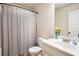 Clean bathroom featuring a shower with a striped curtain, single vanity, and neutral paint at 6140 Stillwood Ln, Cumming, GA 30041
