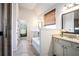 Bright bathroom with soaking tub, tiled walls, and marble vanity at 6140 Stillwood Ln, Cumming, GA 30041