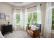 Inviting bedroom corner with accent chair near bright windows and neutral decor at 6140 Stillwood Ln, Cumming, GA 30041