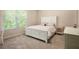 Well-lit bedroom featuring a full bed, carpeted floors, and a large window at 6140 Stillwood Ln, Cumming, GA 30041