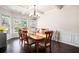 Dining room boasts hardwood floors, wainscoting, coffered ceiling and natural light at 6140 Stillwood Ln, Cumming, GA 30041